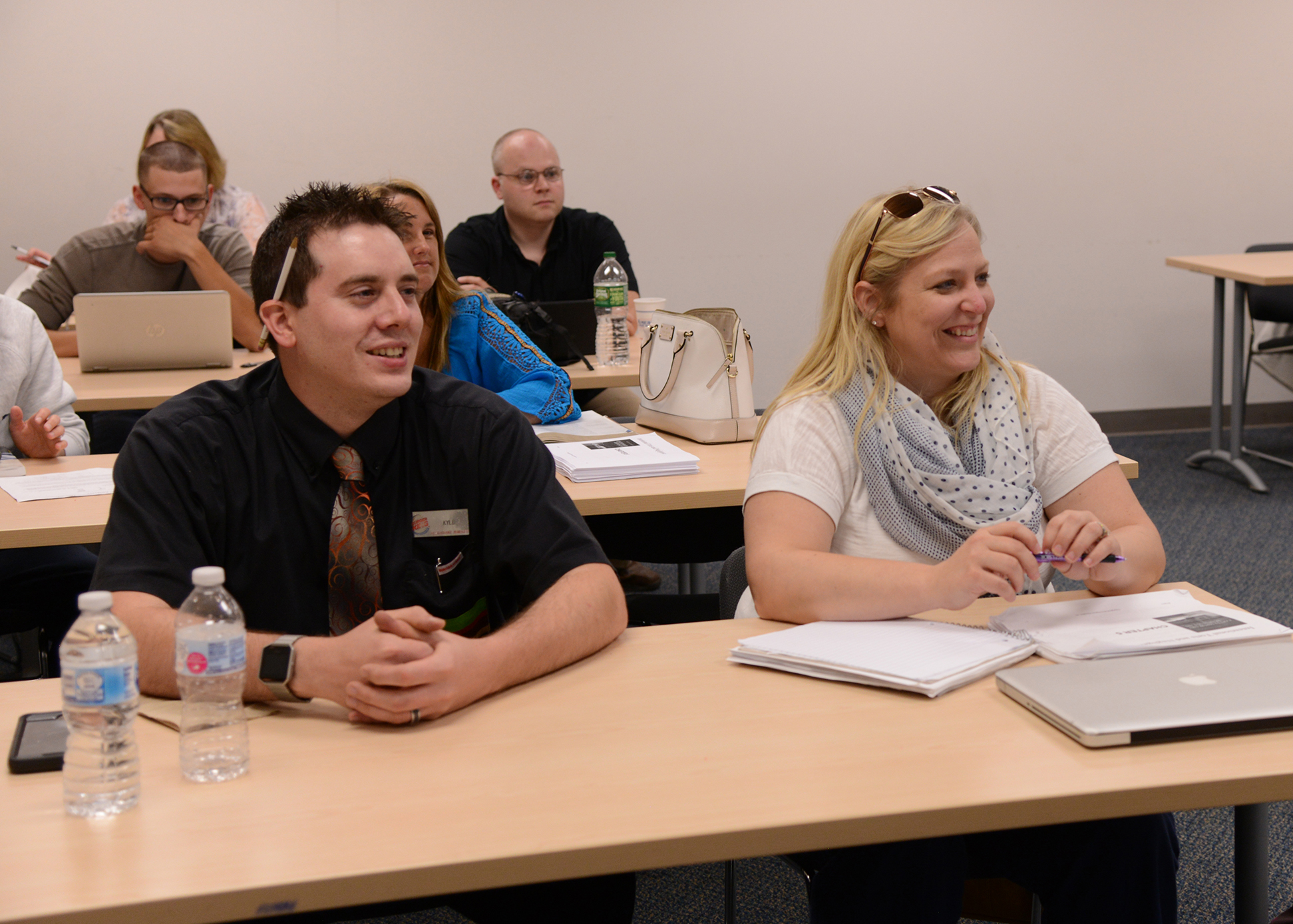 Students in class with computers and notebooks