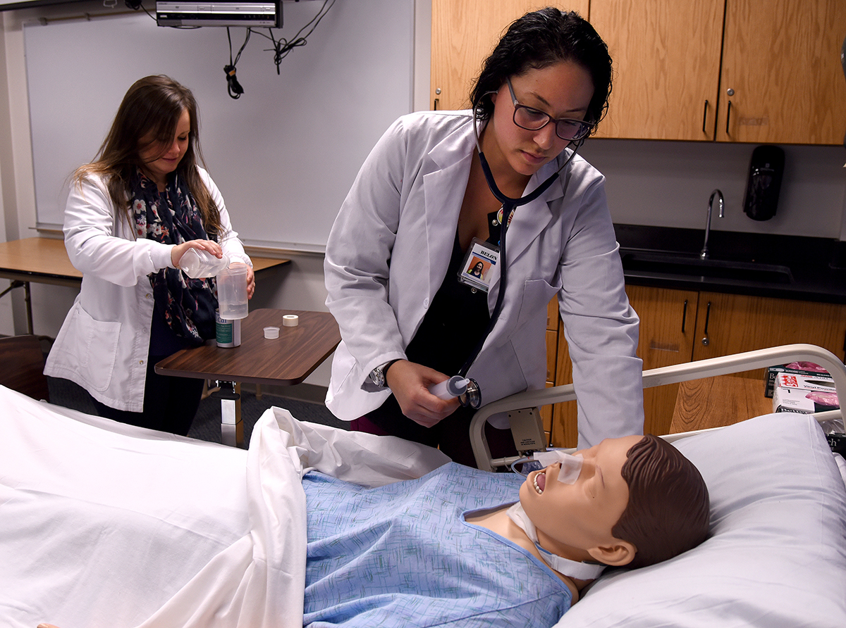 Nursing students working in lab