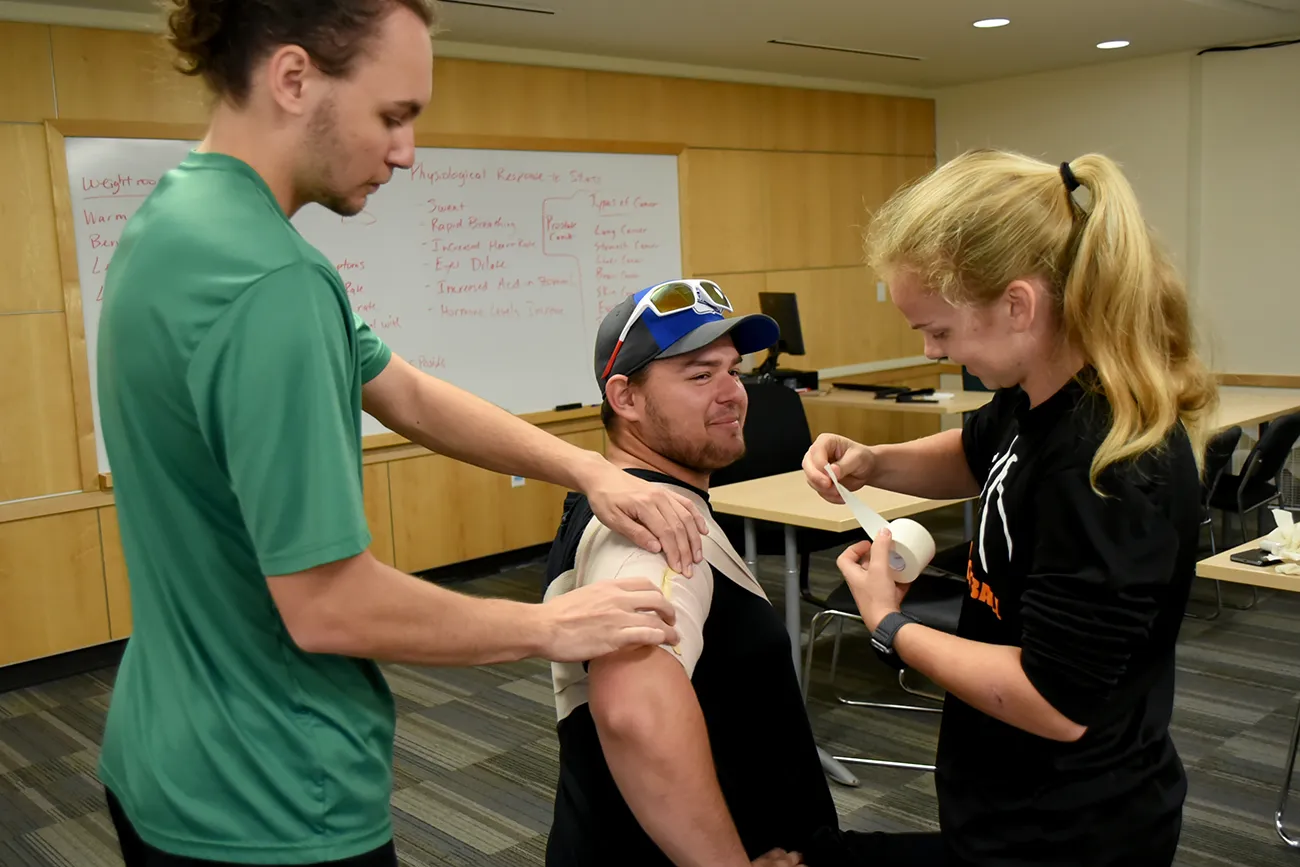 Sports Medicine Sports Medicine students practice taping in class
