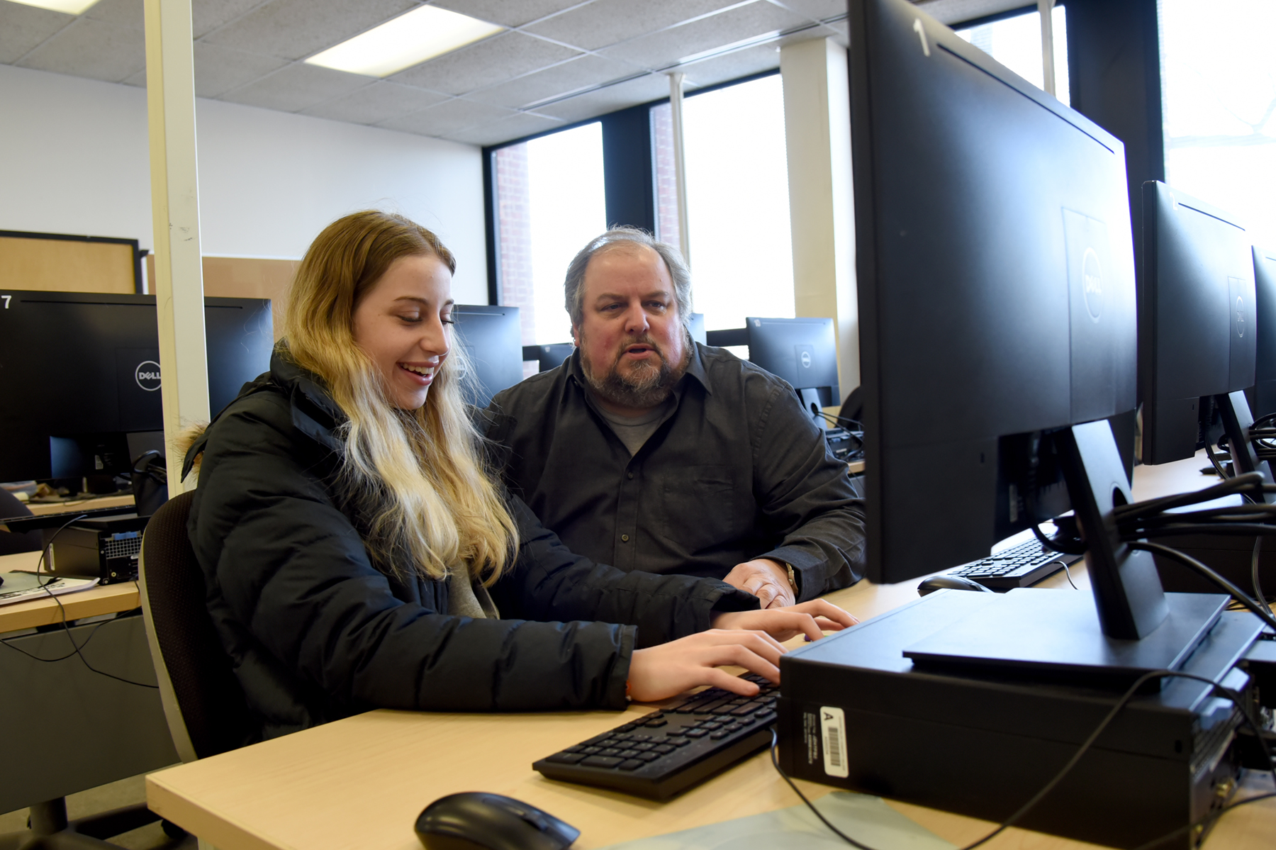 Two people using computer