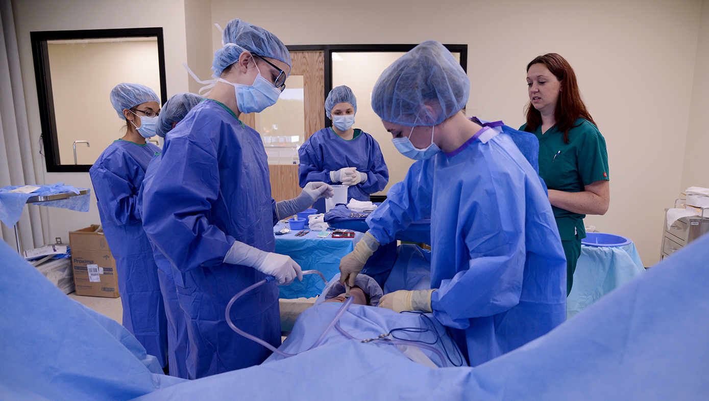 Surgical technician students working in lab setting