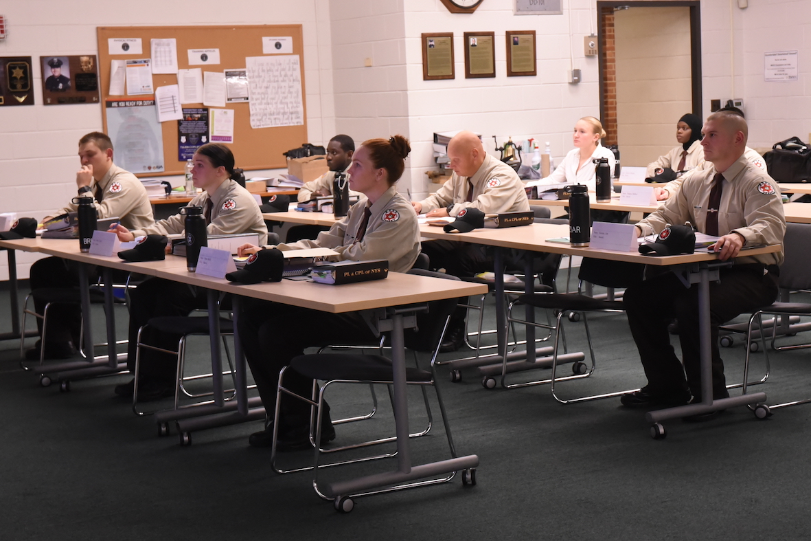 Students in uniforms sit in a classroom