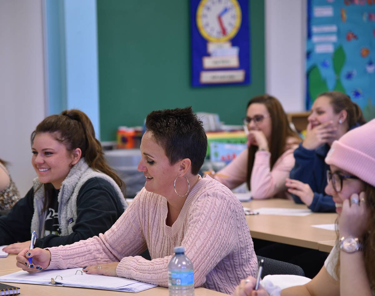 Students in classroom, smiling