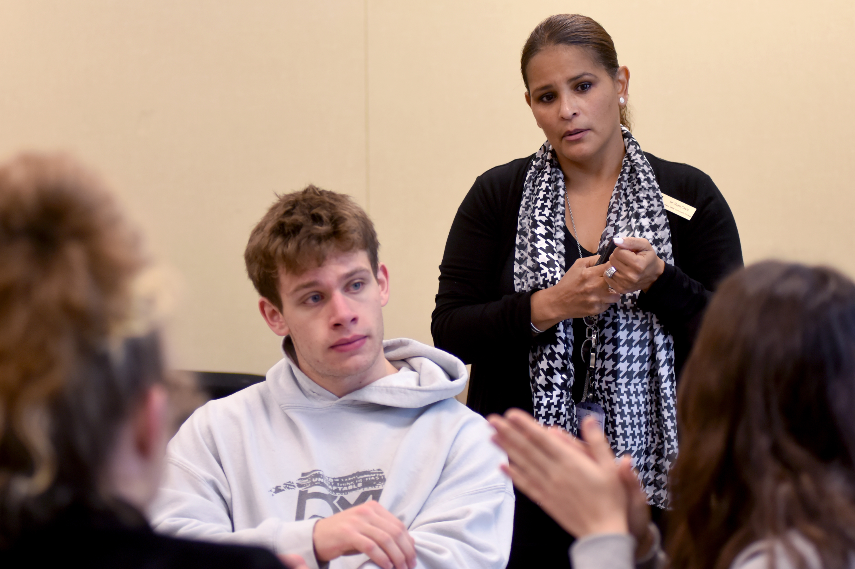 Professor listening to student in class