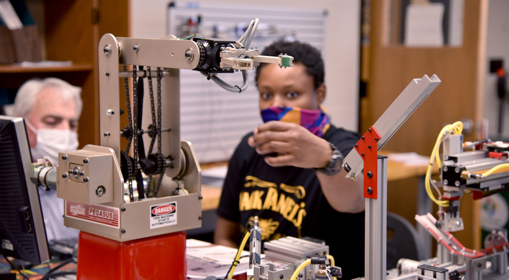 Student working on a robotics assembly at MVCC Mechatronics Lab