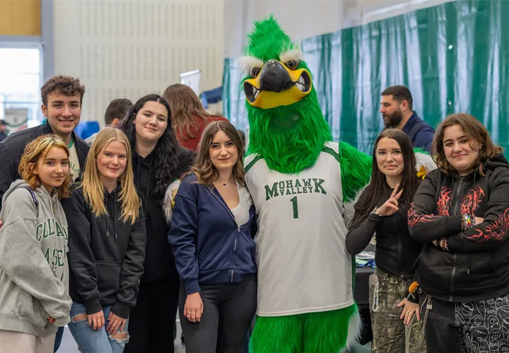 Group of students standing with MVCC mascot Mo Hawk