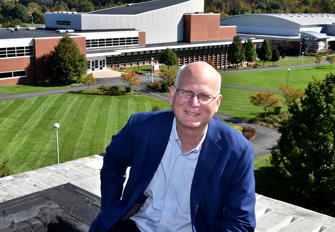 Alumnus Christopher Crolius on roof overlooking MVCC campus