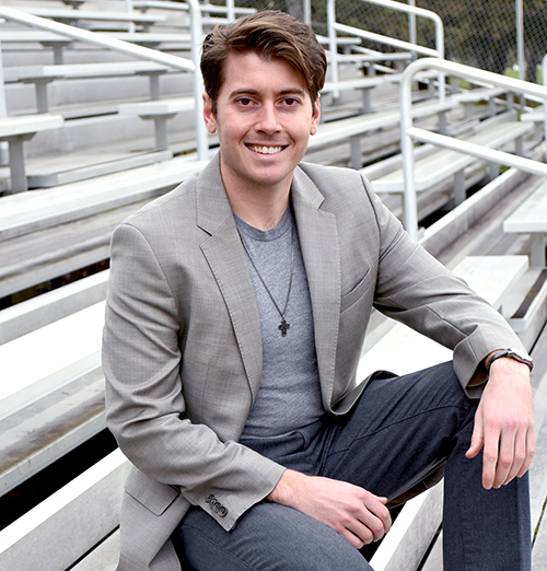 MVCC alum David Gould sits on bleachers outside