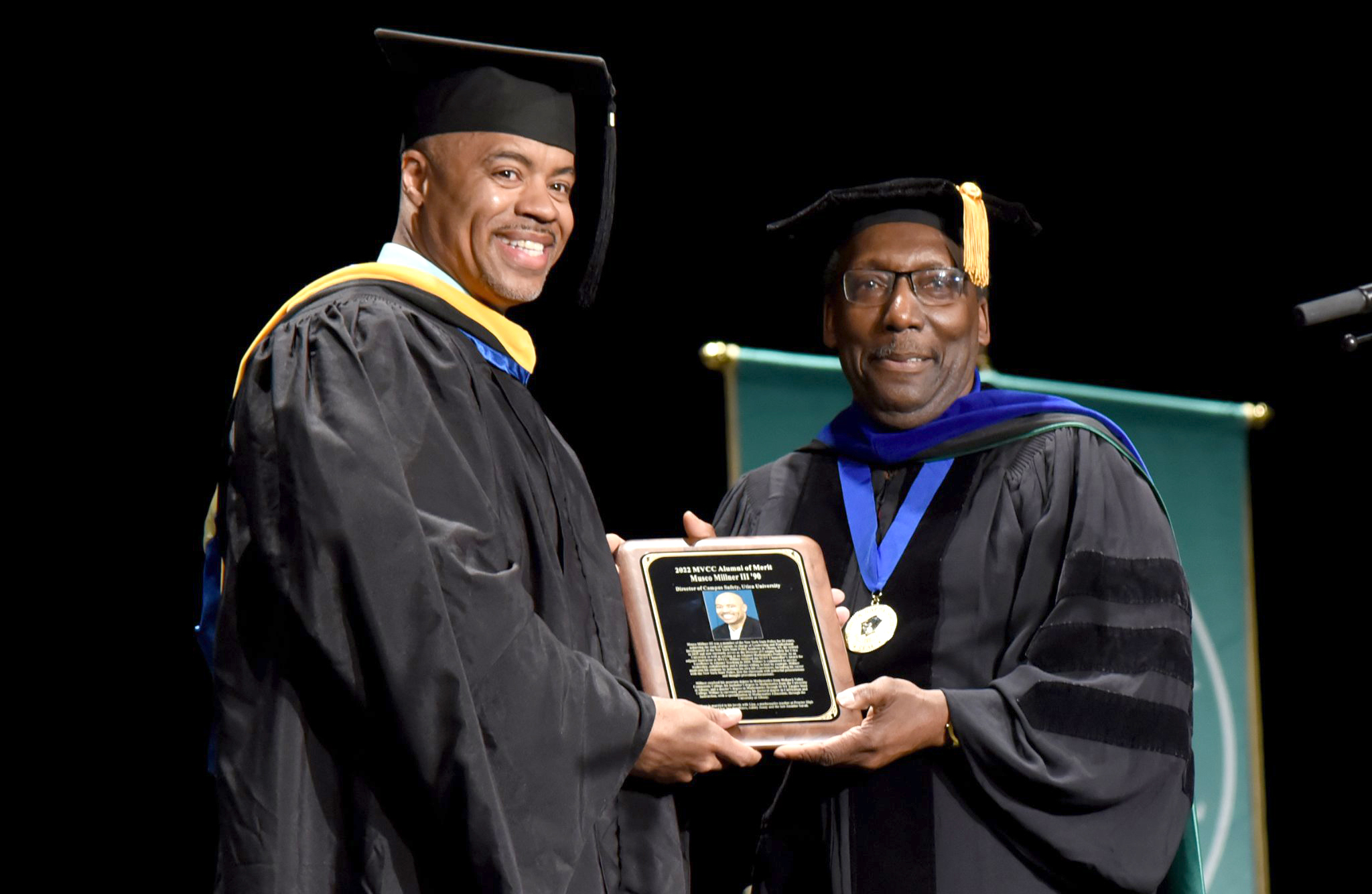 Image of Musco Millner III receiving the 2022 Alumni of Merit Award from MVCC Trustee David Mathis