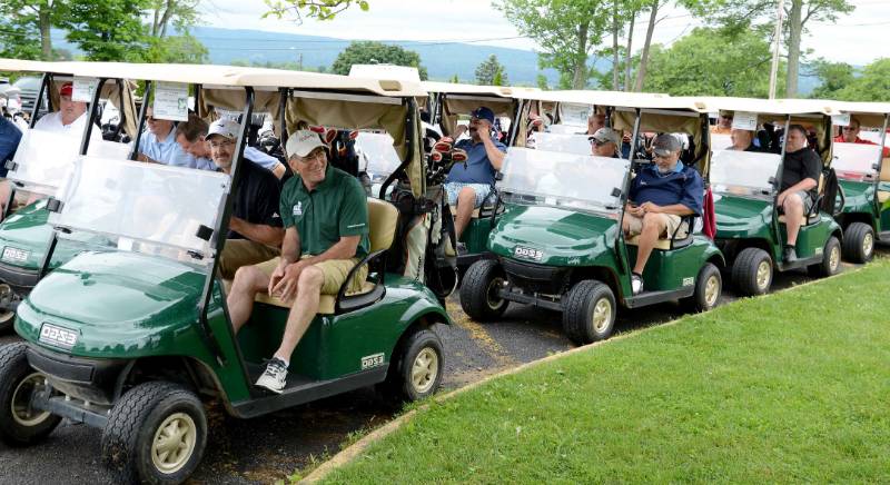 Image of golfers in golf carts ready to start tournament