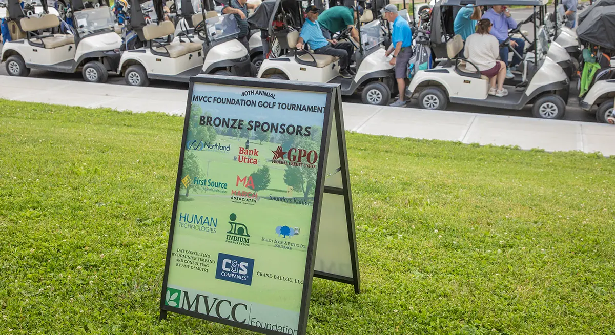 Sponsor Signage in front of golfers enjoying their conversations at the Golf Course Sponsor Signage in front of golfers enjoying their conversations at the Golf Course
