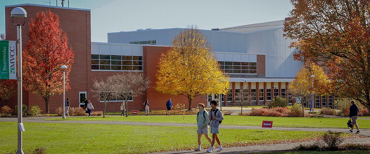 Students in front of Wilcox Hall on Utica Campus under a nice fall weather