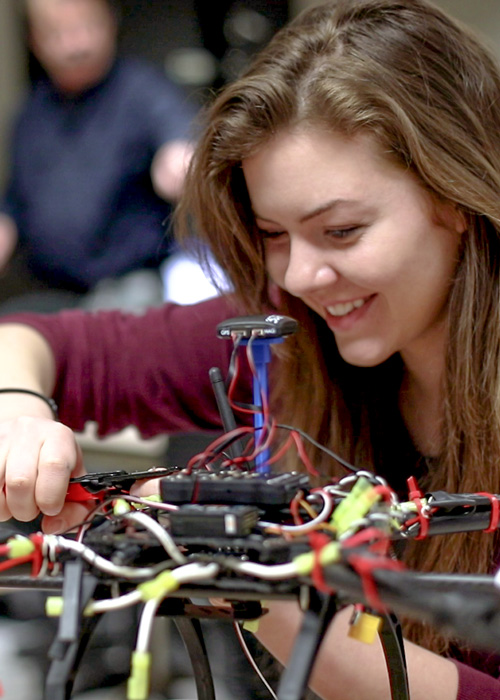 student performing maintenance on a drone