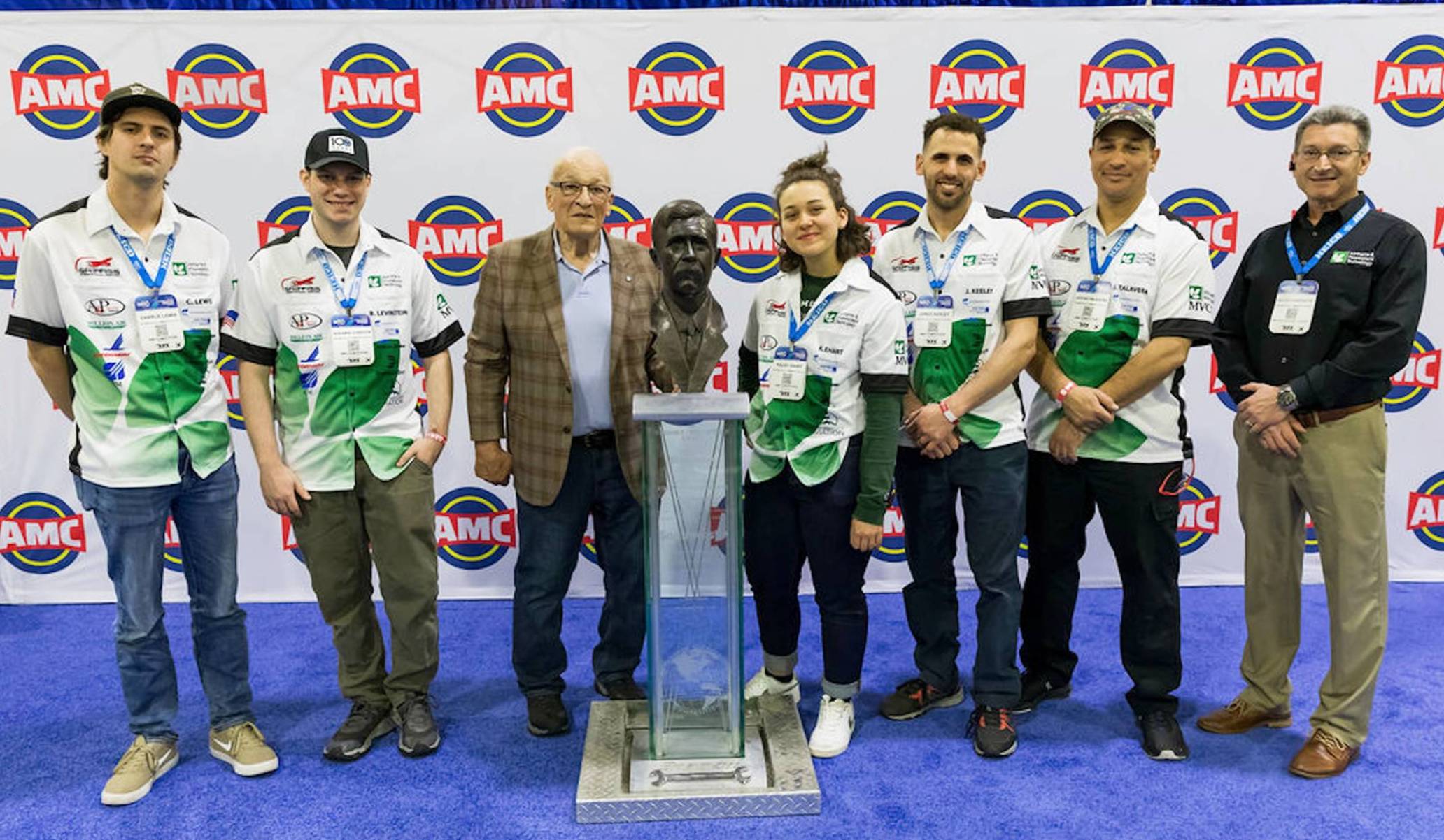 Group of people standing together with award