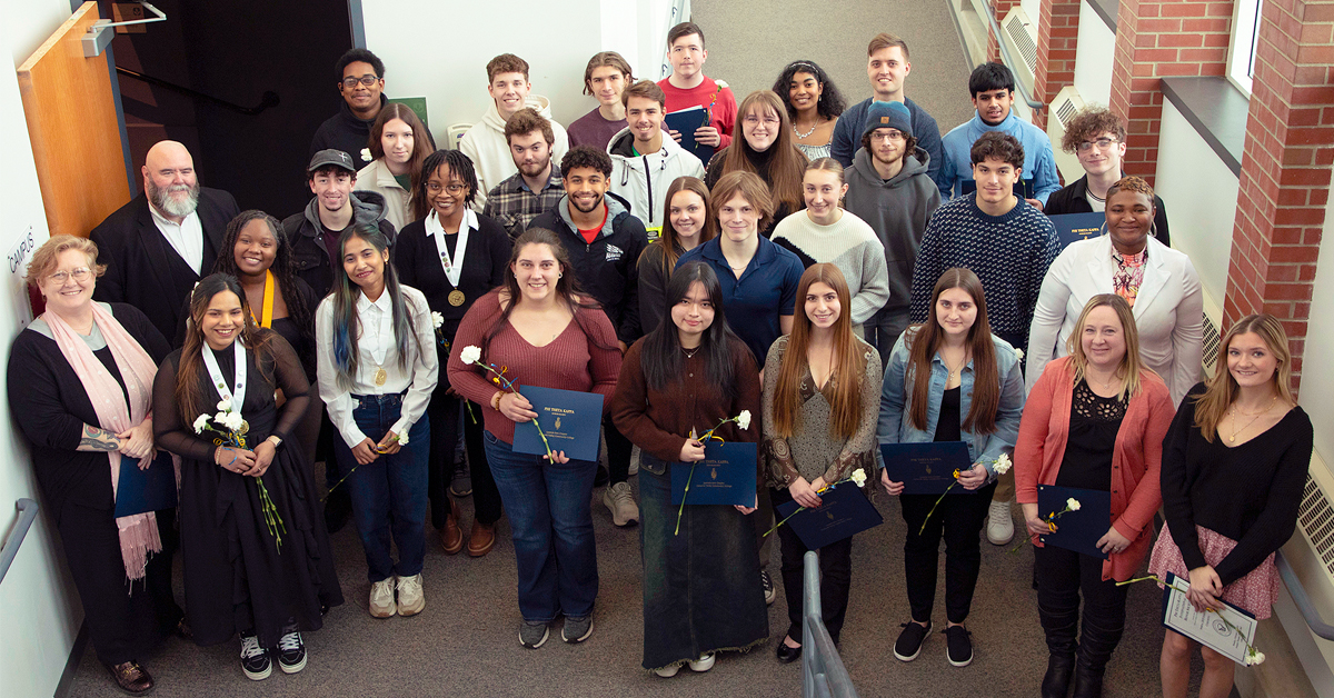 Group of students standing with Phi Theta Kappa membership honors